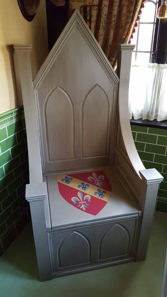 A throne toilet with coat of arms