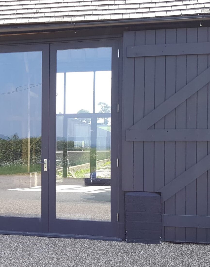 Wooden windows visible through bifold doors