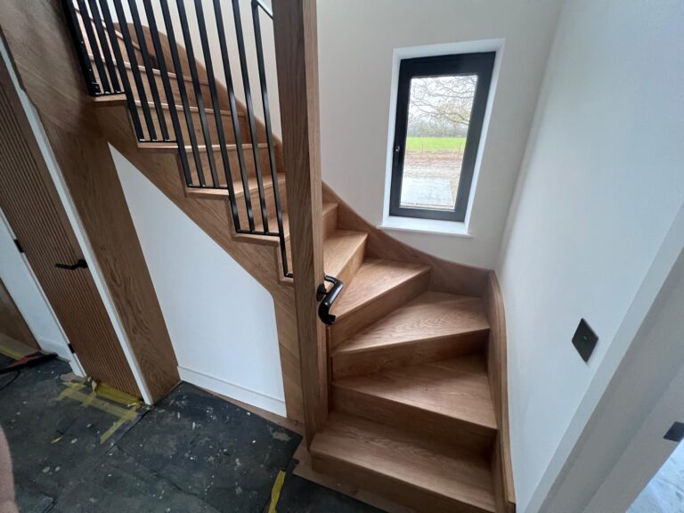 Oak stairs with black metal balustrade and handrail